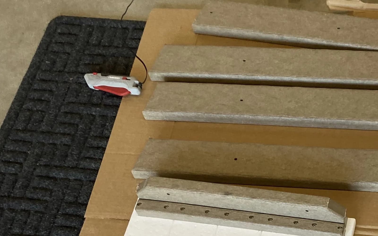 Furniture components, hardware, instructions, and protective material laid out before assembly begins.