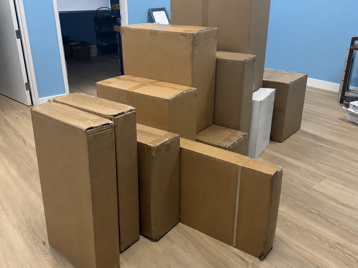 Furniture boxes staged in a Mission Hills office before assembly