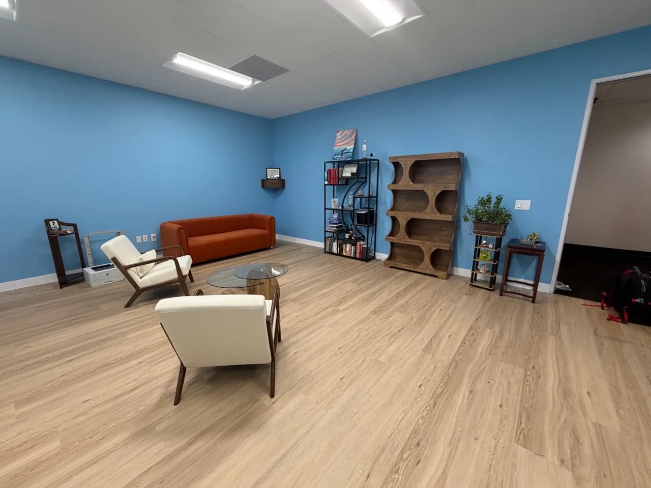 Finished Mission Hills office with assembled seating, tables, and shelving