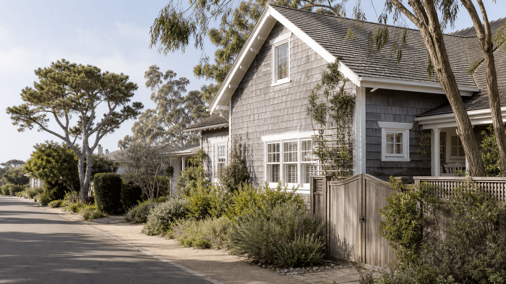 Illustrative shingle coastal cottage on a Del Mar residential street.
