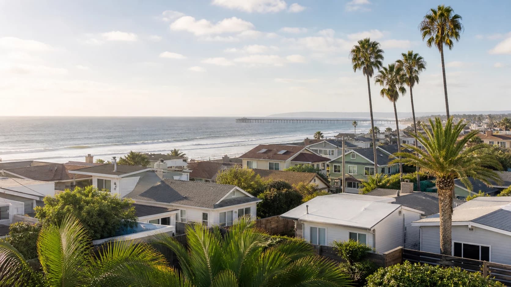 Illustrative Ocean Beach coastal neighborhood with bungalows, palms, shoreline, and a distant pier.